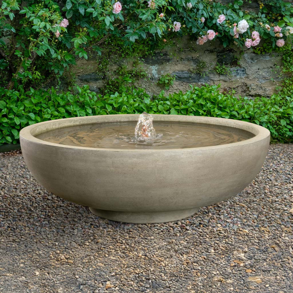Cast stone garden bowl fountain with water feature in a garden setting