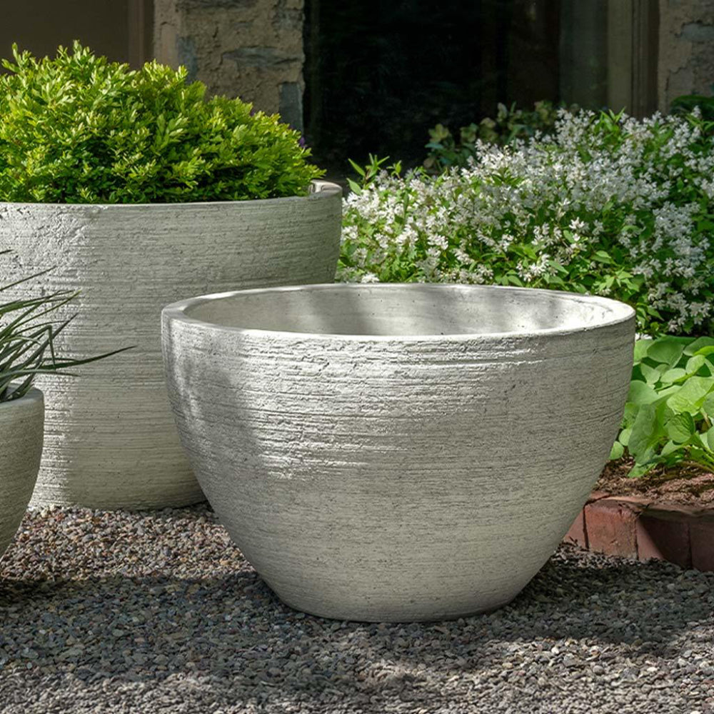 Decorative stone planters in a garden setting
